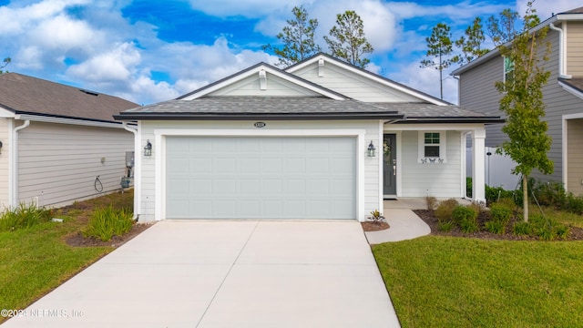 view of front of property with a garage and a front yard