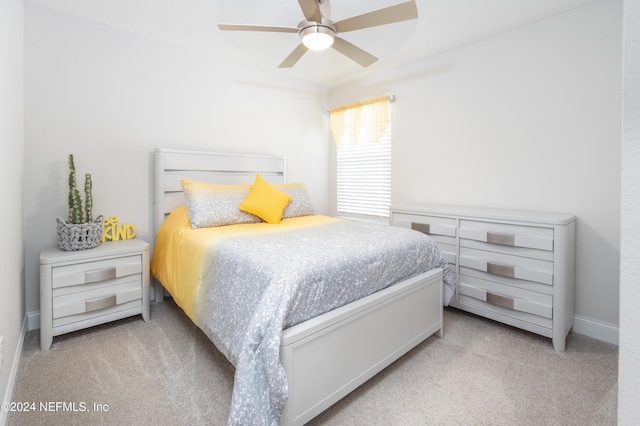 bedroom featuring light colored carpet and ceiling fan