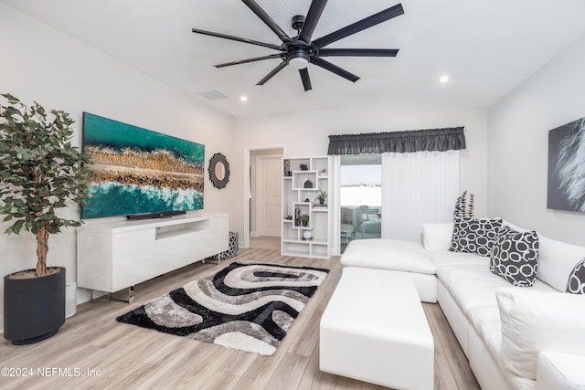 living room with light hardwood / wood-style floors, lofted ceiling, and ceiling fan