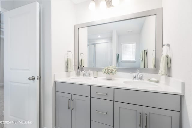 bathroom featuring vanity and a shower with shower door