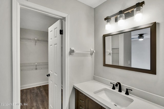 bathroom with ceiling fan, wood-type flooring, and vanity