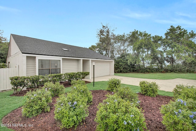 view of front of home with a garage and a front yard