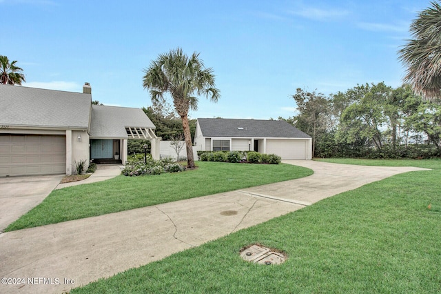 view of front of property featuring a garage and a front yard