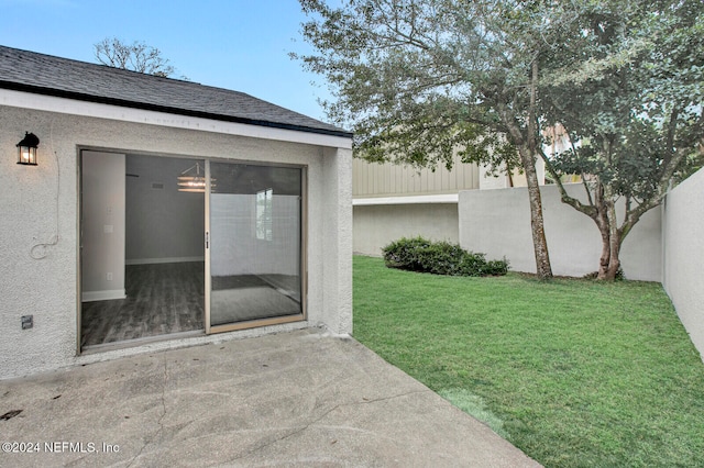 doorway to property featuring a yard and a patio area