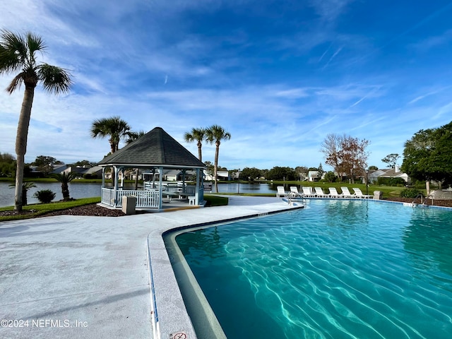 view of swimming pool with a water view and a gazebo