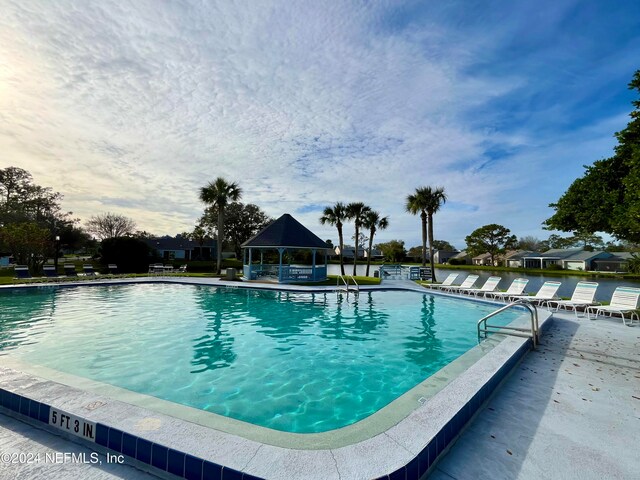 view of swimming pool featuring a gazebo and a patio area