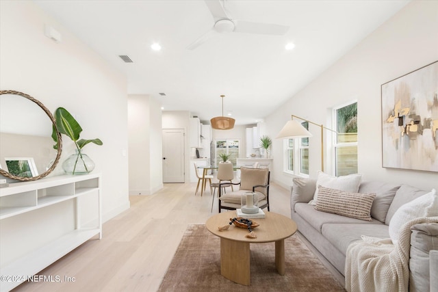 living room with ceiling fan and light wood-type flooring