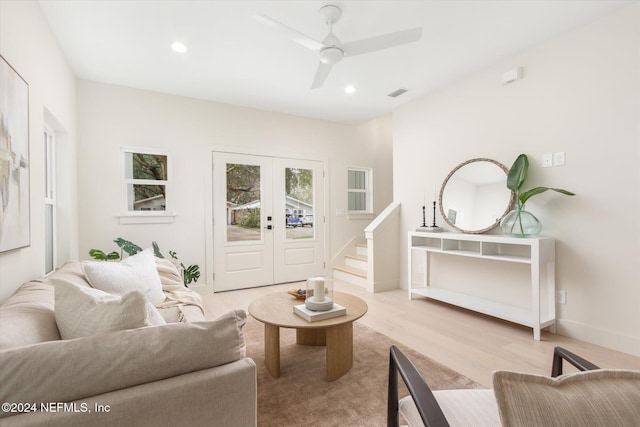 living room with ceiling fan, french doors, and light wood-type flooring