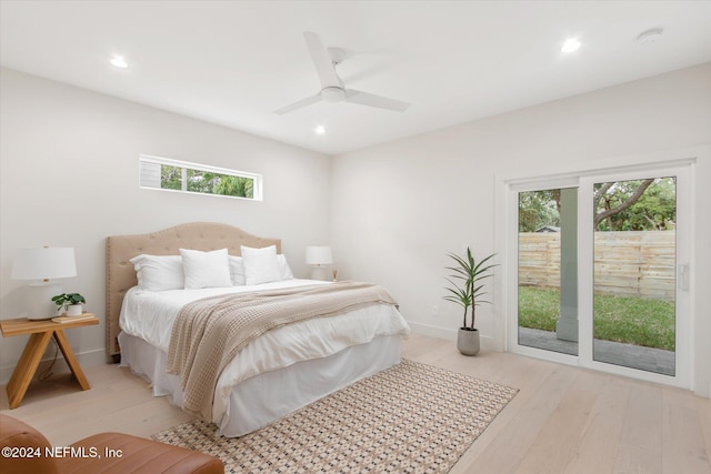 bedroom with access to exterior, ceiling fan, light hardwood / wood-style flooring, and multiple windows