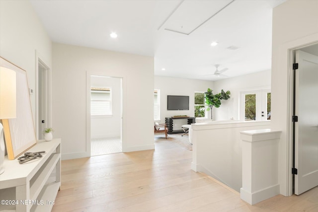 corridor with light hardwood / wood-style flooring