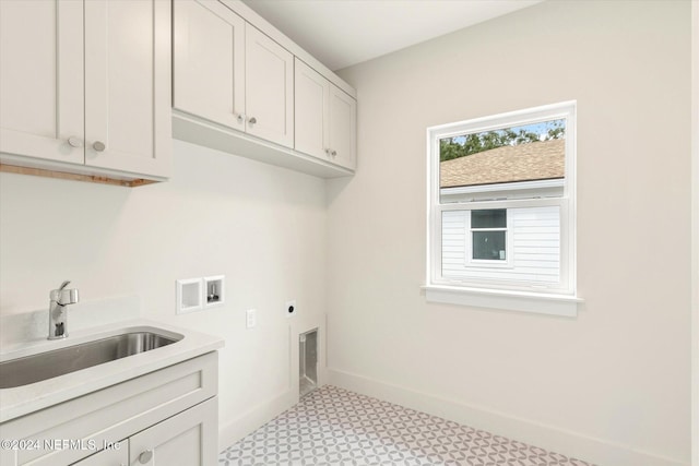 clothes washing area with washer hookup, hookup for an electric dryer, cabinets, and sink