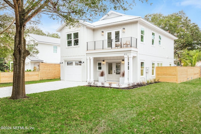 view of front of home with covered porch, a balcony, a front yard, and french doors