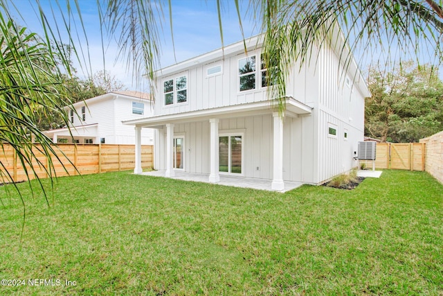 back of house with a lawn and a patio area