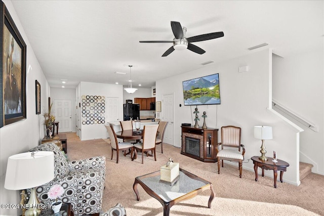 living room featuring ceiling fan and light colored carpet