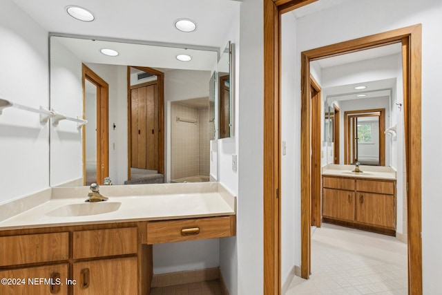 bathroom featuring vanity and tiled shower