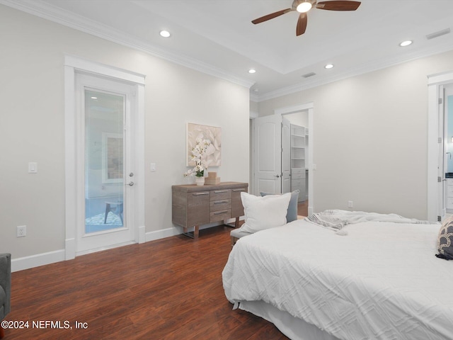 bedroom featuring dark hardwood / wood-style flooring, ornamental molding, ceiling fan, a closet, and a spacious closet