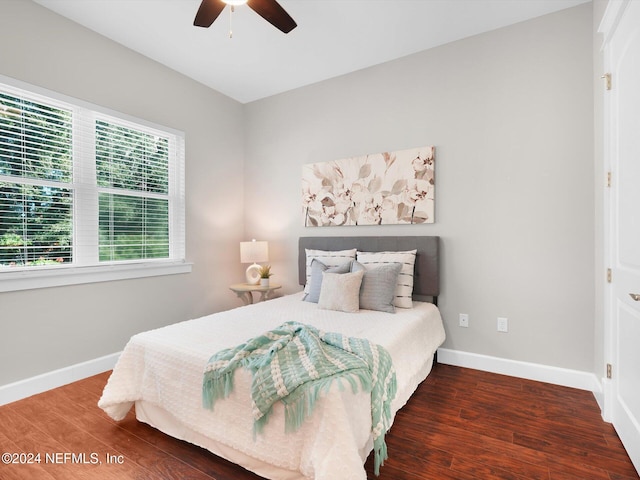 bedroom with ceiling fan and dark hardwood / wood-style flooring