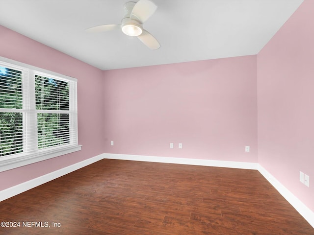 spare room featuring ceiling fan and dark hardwood / wood-style floors