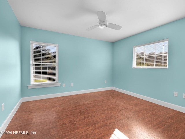 empty room with hardwood / wood-style flooring and ceiling fan