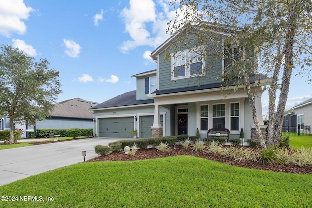 view of front of home with a garage, a front yard, and a porch