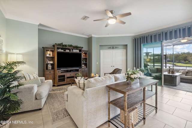 living room with light tile patterned floors, ceiling fan, and crown molding