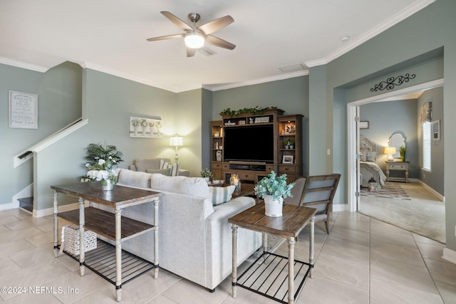 carpeted living room featuring ornamental molding and ceiling fan