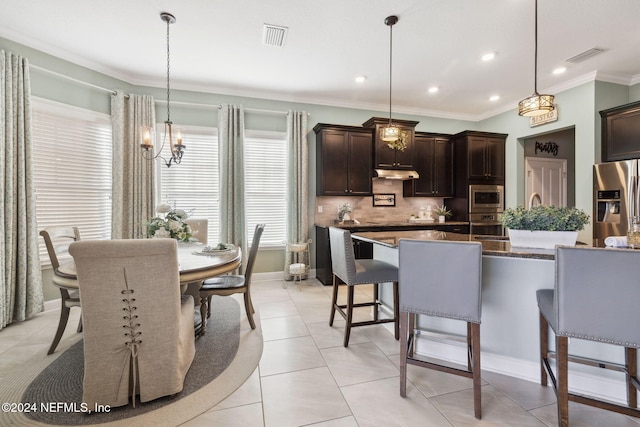 kitchen featuring dark brown cabinets, stainless steel appliances, hanging light fixtures, and a center island