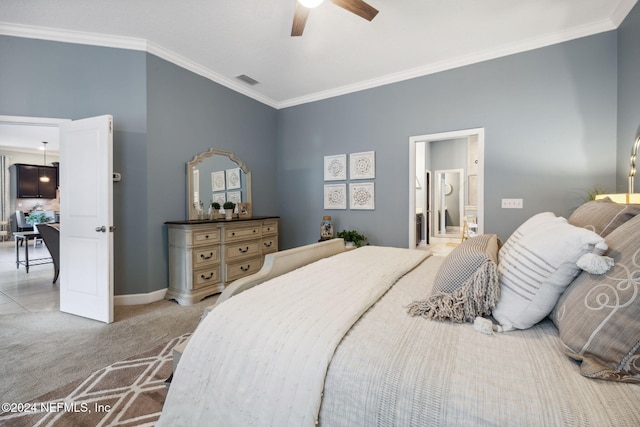 carpeted bedroom featuring ornamental molding, ceiling fan, and ensuite bath