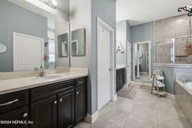 bathroom featuring vanity, tile patterned flooring, and separate shower and tub