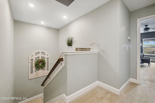 stairs featuring carpet floors