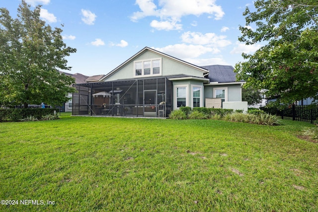 rear view of property with a lawn