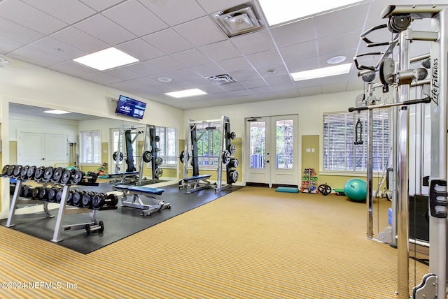 gym with french doors and a drop ceiling