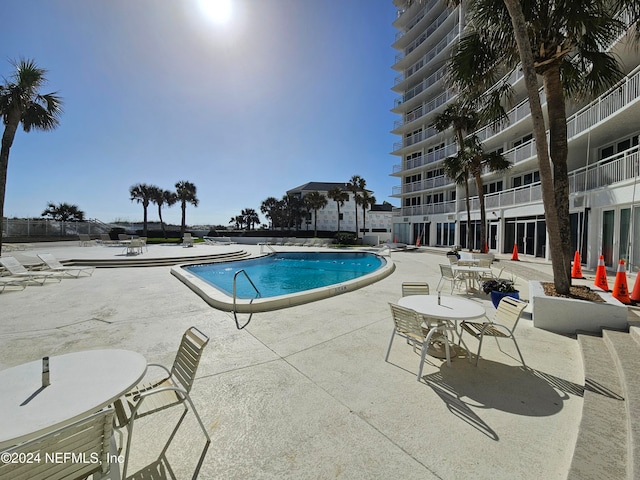 view of swimming pool featuring a patio area