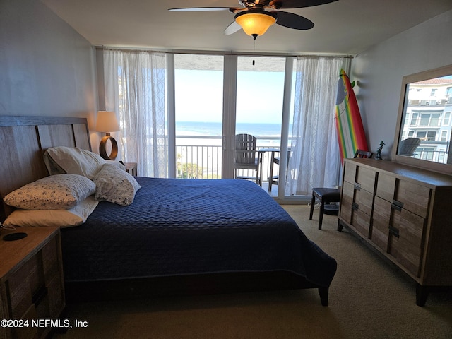 carpeted bedroom with access to outside, a water view, and ceiling fan