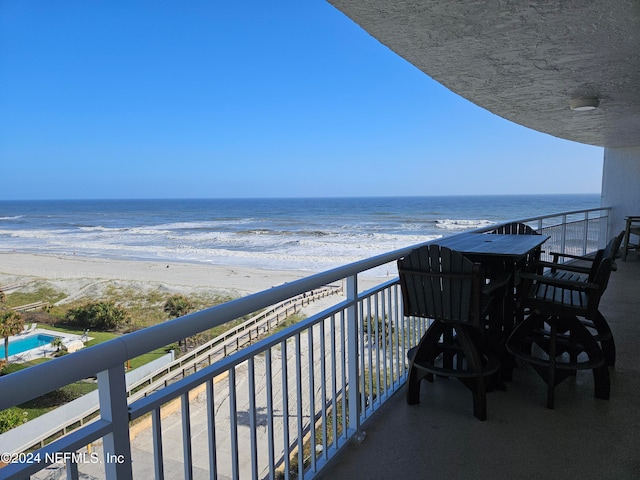 balcony with a view of the beach and a water view