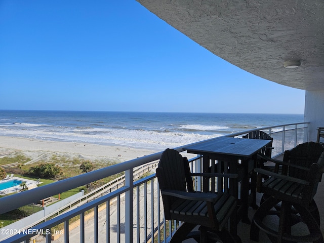 balcony with a view of the beach and a water view