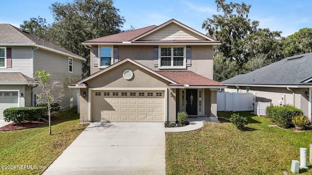 view of property featuring a garage and a front lawn