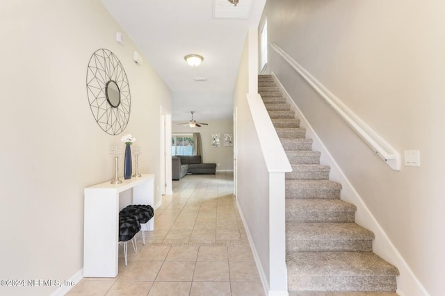 stairs with tile patterned flooring and ceiling fan