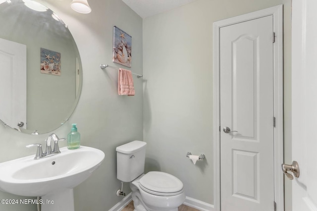 bathroom featuring sink and toilet