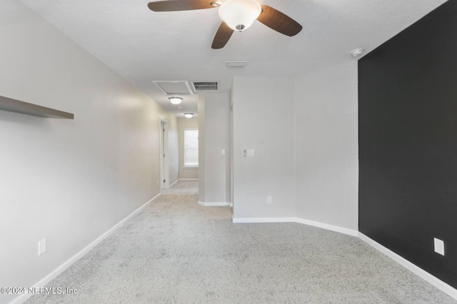 empty room featuring light carpet and ceiling fan