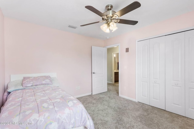 unfurnished bedroom with a closet, light colored carpet, and ceiling fan