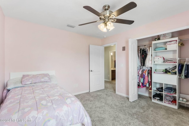 carpeted bedroom featuring ceiling fan and a closet