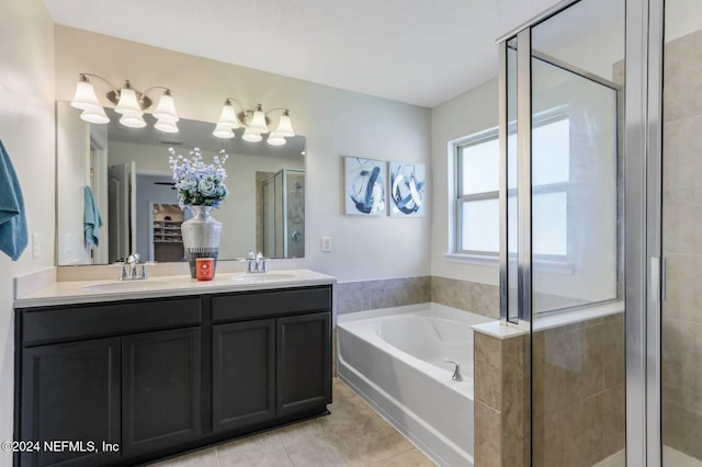 bathroom featuring plus walk in shower, vanity, and tile patterned floors