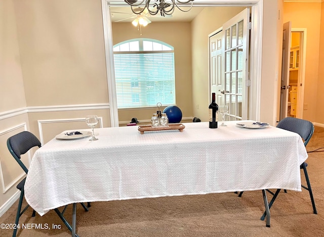 dining space featuring carpet and ceiling fan