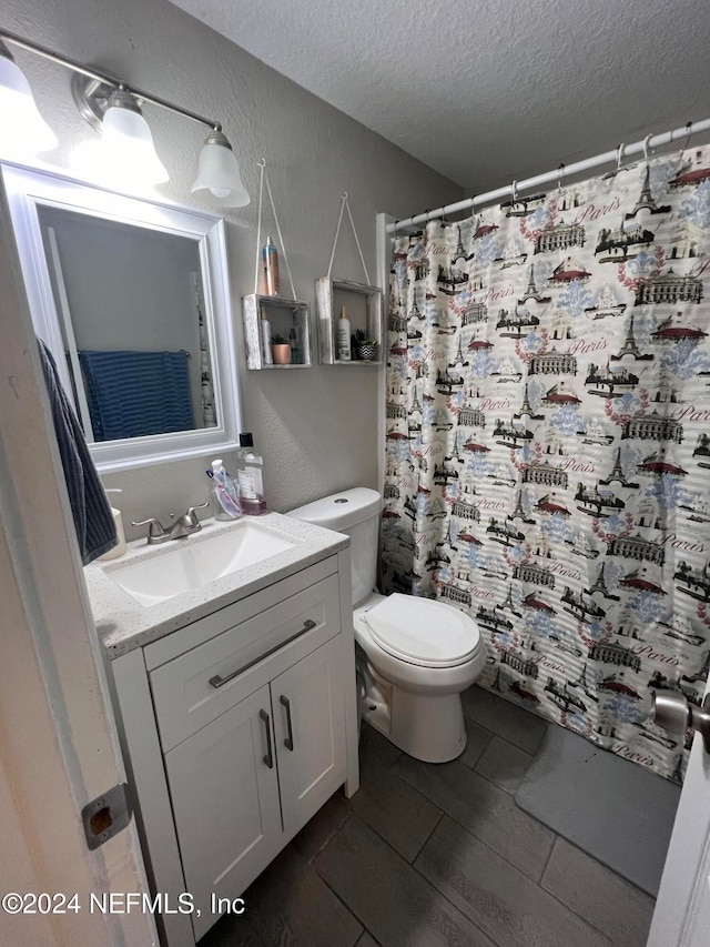 bathroom with vanity, a textured ceiling, toilet, and a shower with shower curtain