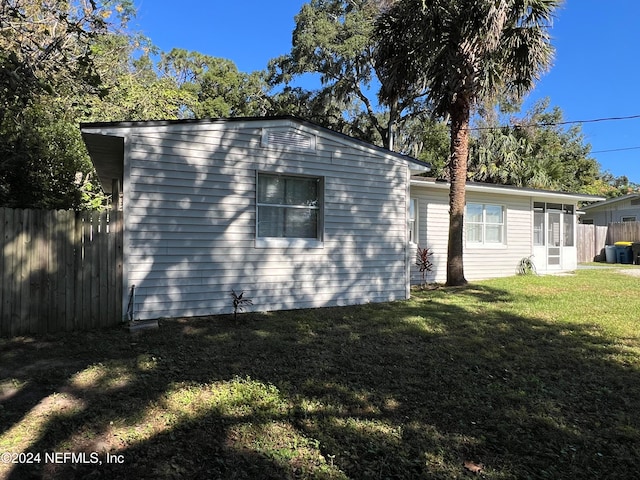 view of property exterior with a yard