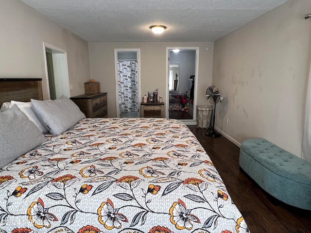 bedroom with a textured ceiling, ensuite bathroom, and dark hardwood / wood-style floors