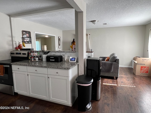 kitchen featuring a textured ceiling, stone counters, white cabinets, dark hardwood / wood-style floors, and stainless steel range with electric cooktop