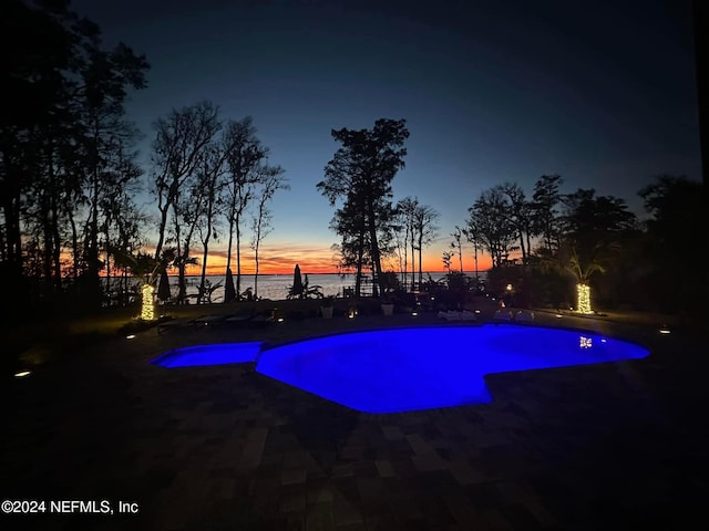 pool at dusk with a water view