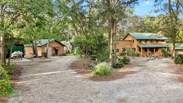 7816 Whispering Pines Ln, Glen St Mary, FL 32040 - view of front of house with driveway, a porch, and an outdoor structure